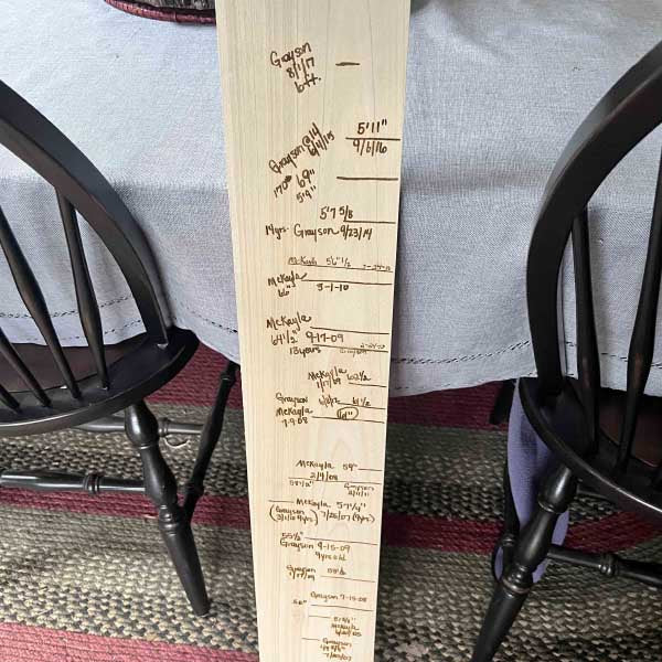 Children's growth chart engraved into wood.
