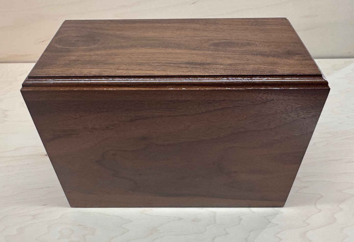 Wooden box with a dark brown finish on a light gray background