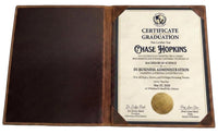 Graduation certificate in a leather holder with a gold seal