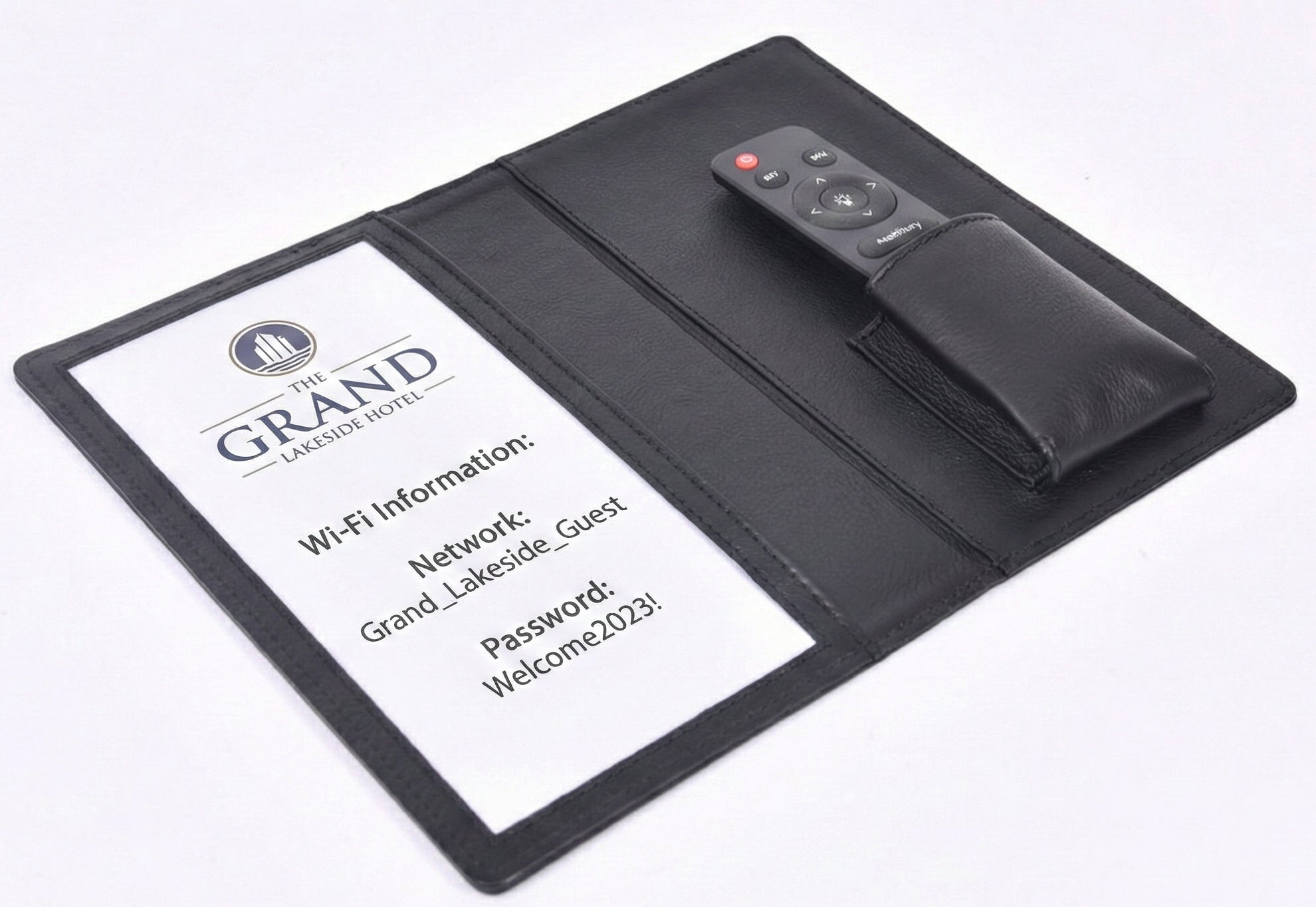 Personalized black full-grain leather TV remote case with custom embossed Memories Made logo for luxury home organization.