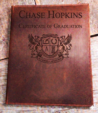 Professional leather certificate cover made in Canada featuring secure corner tabs and personalized laser engraving for