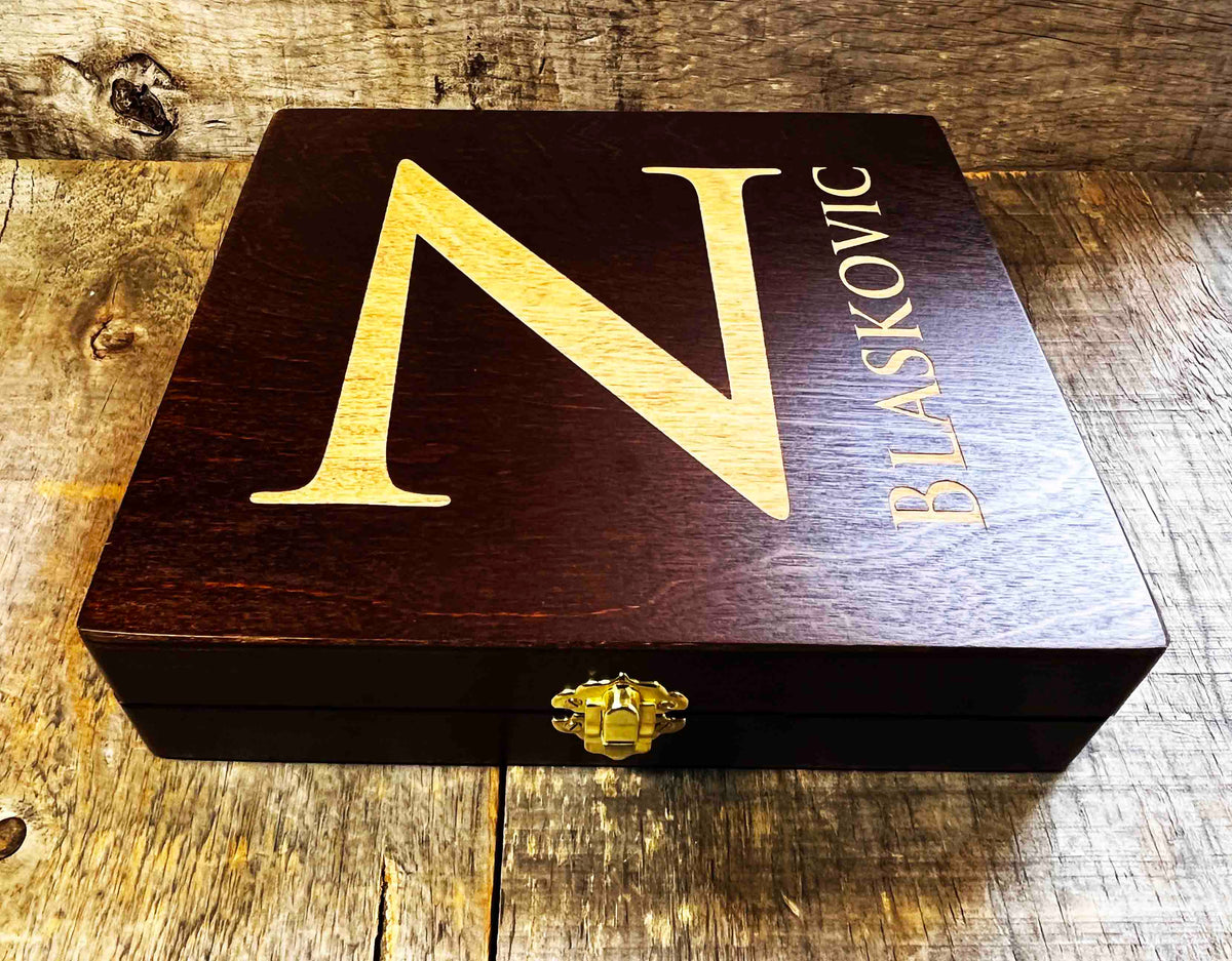 Wooden box with 'N Blaskovic' branding on a wooden surface