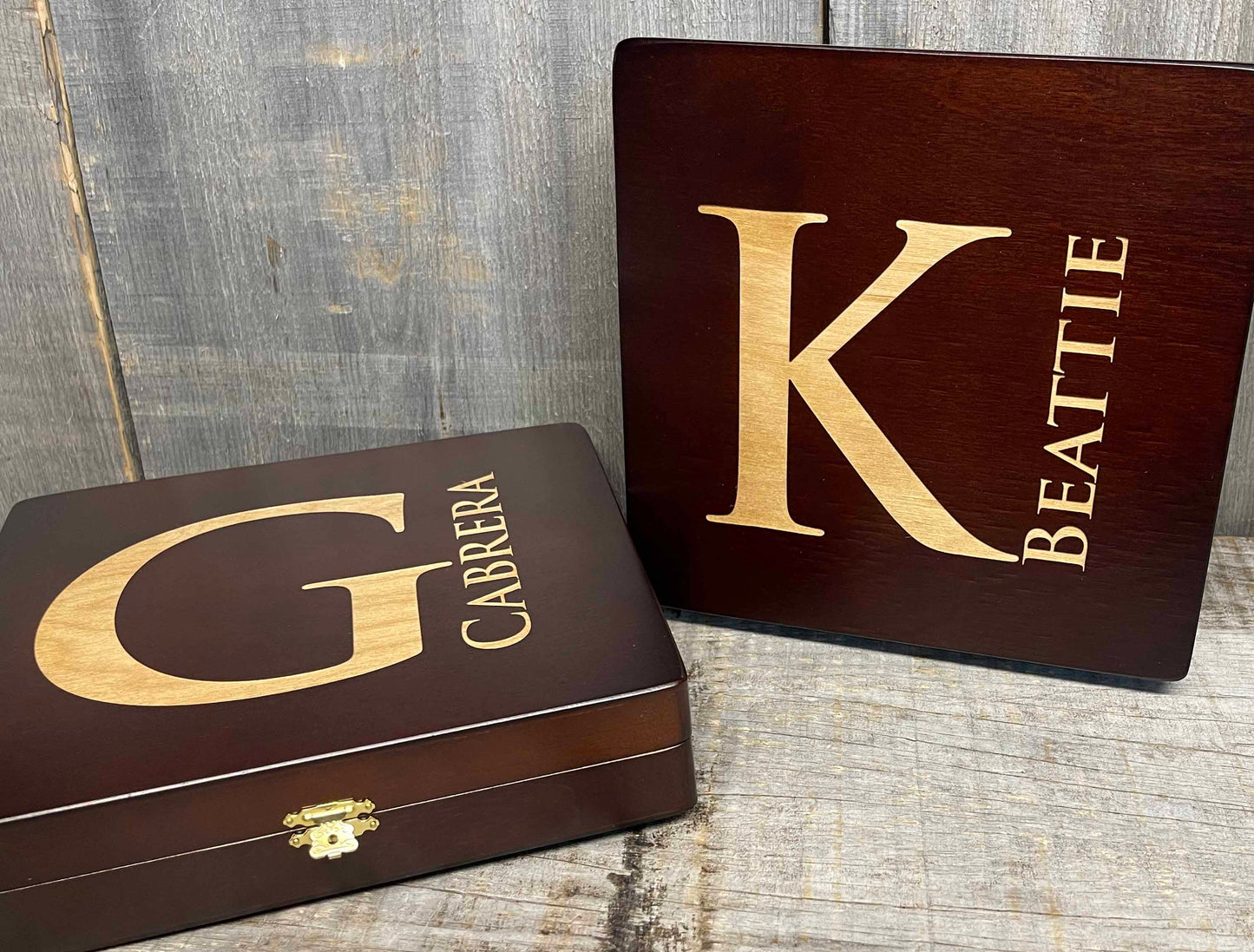 Two wooden boxes with gold lettering on a rustic wooden surface