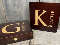 Two wooden boxes with gold lettering on a rustic wooden surface