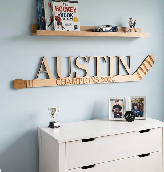 Personalized wooden mini hockey stick with custom laser-cut name.