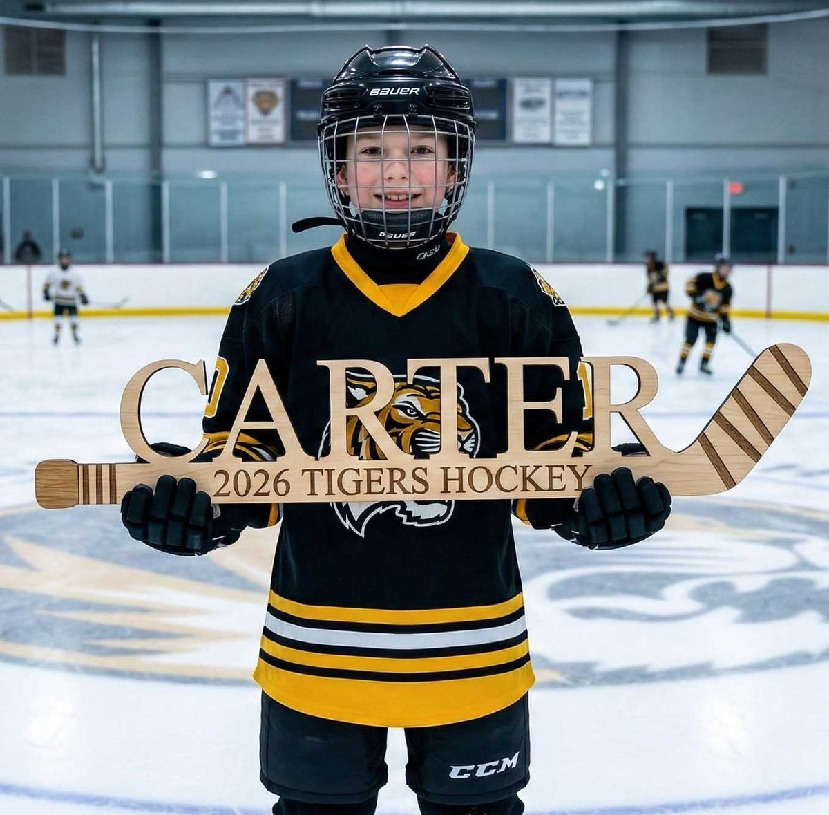 Young hockey player holding a personalized hockey stick on an ice rink
