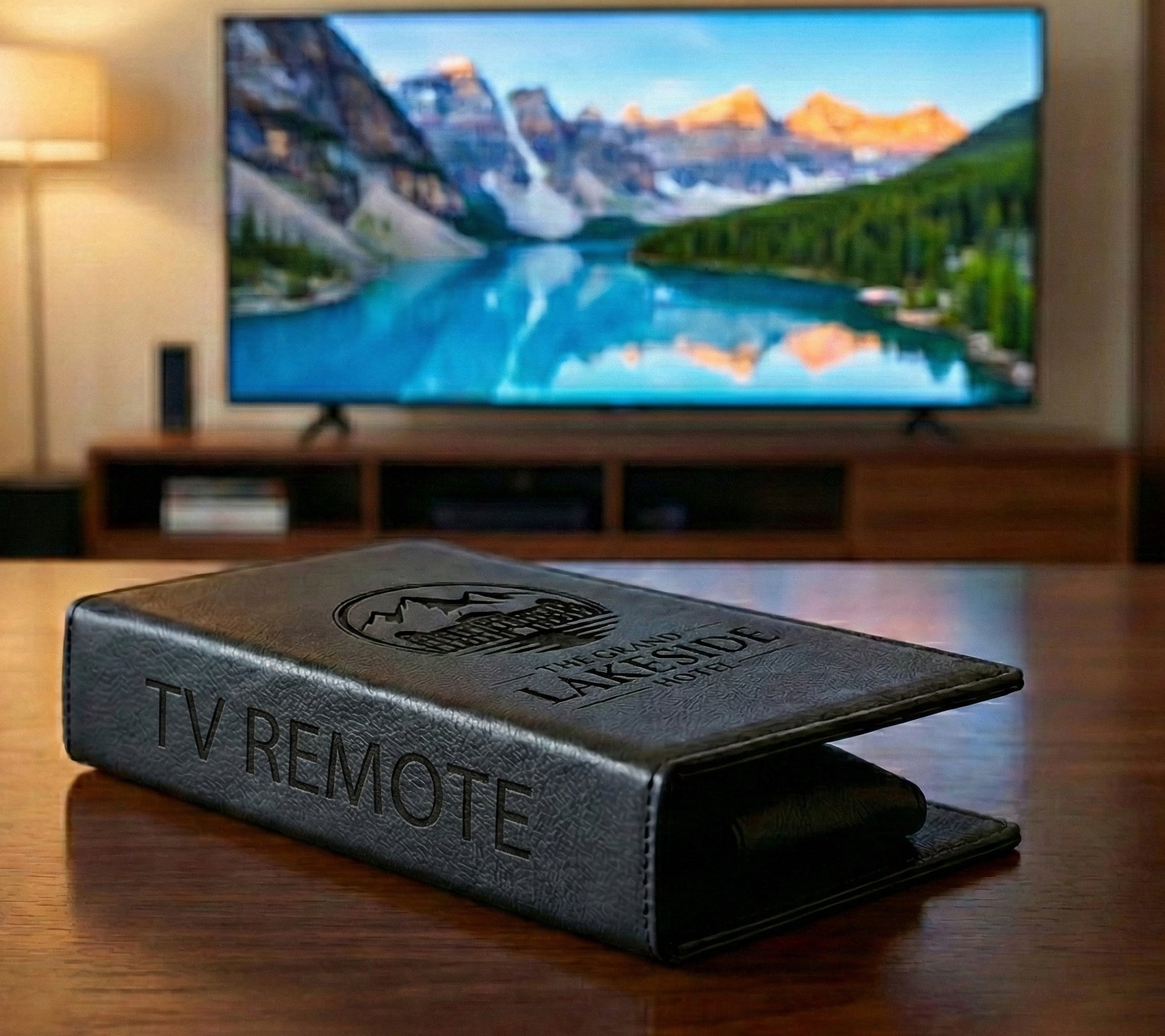 Personalized black full-grain leather TV remote case with custom embossed Memories Made logo for luxury home organization.