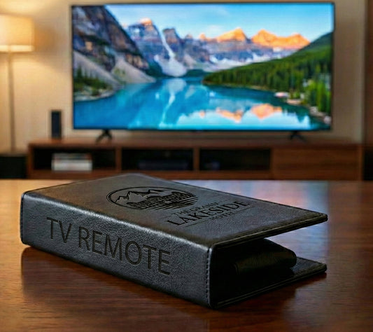 Personalized black full-grain leather TV remote case with custom embossed Memories Made logo for luxury home organization.