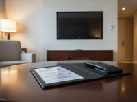 Personalized black full-grain leather TV remote case with custom embossed Memories Made logo for luxury home organization.