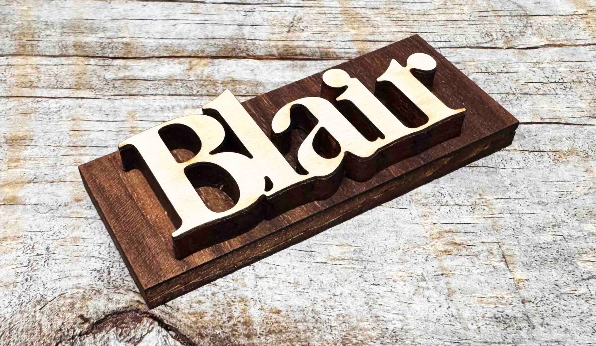Wooden nameplate with 'Blair' engraved on a wooden surface