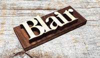 Wooden nameplate with 'Blair' engraved on a wooden surface