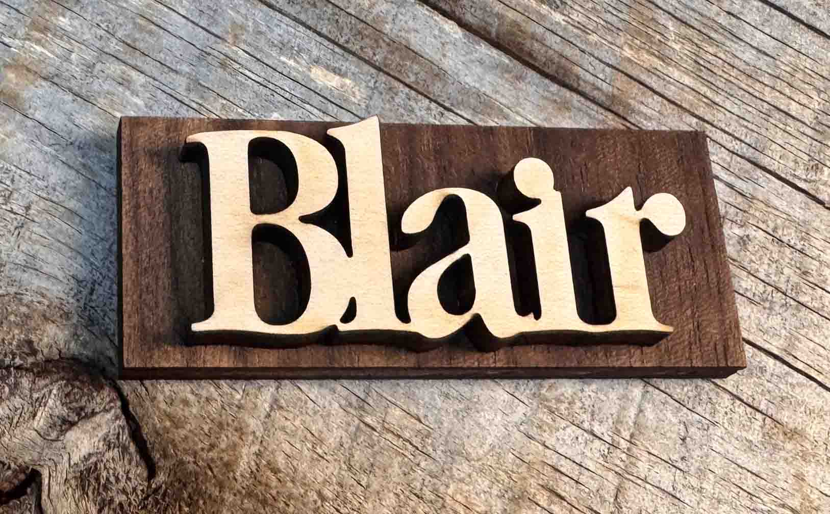 Wooden nameplate with 'Blair' on a wooden background