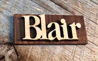 Wooden nameplate with 'Blair' on a wooden background