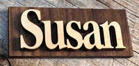 Wooden sign with the name 'Susan' on a wooden surface