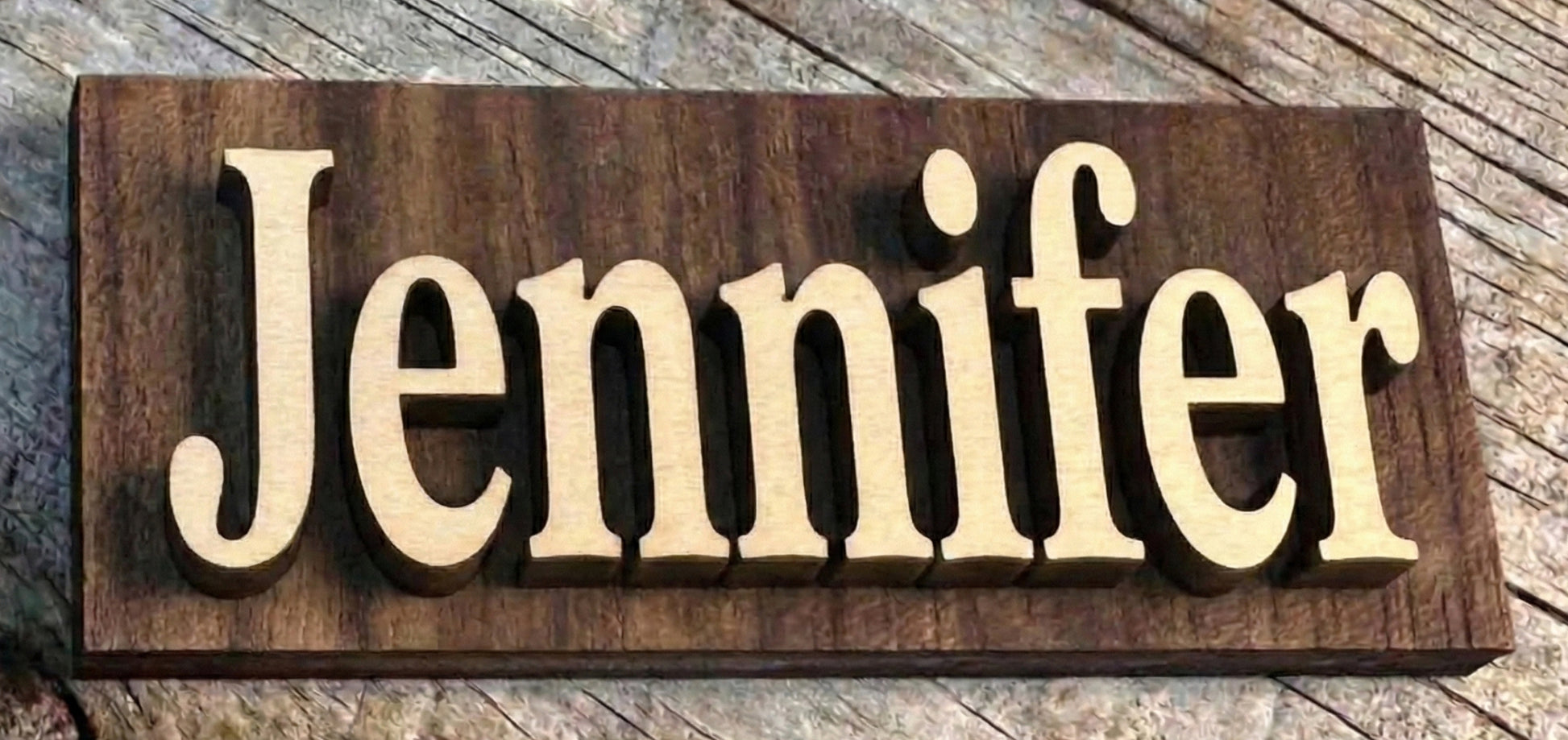 Wooden sign with the name 'Jennifer' on a wooden surface